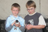 Hans Meinhard og Poul Johannes við hvør sínari ringmerktari lundapisu / Hans Meinhard og Poul Johannes med hver sin ringmærkede lundeunge / Hans Meinhard and Poul Johannes each holding a ringed young Puffin.